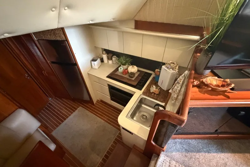 Slide: The Image of Interior view of a 1990 Viking 44 Motor Yacht kitchen with modern amenities. - 33