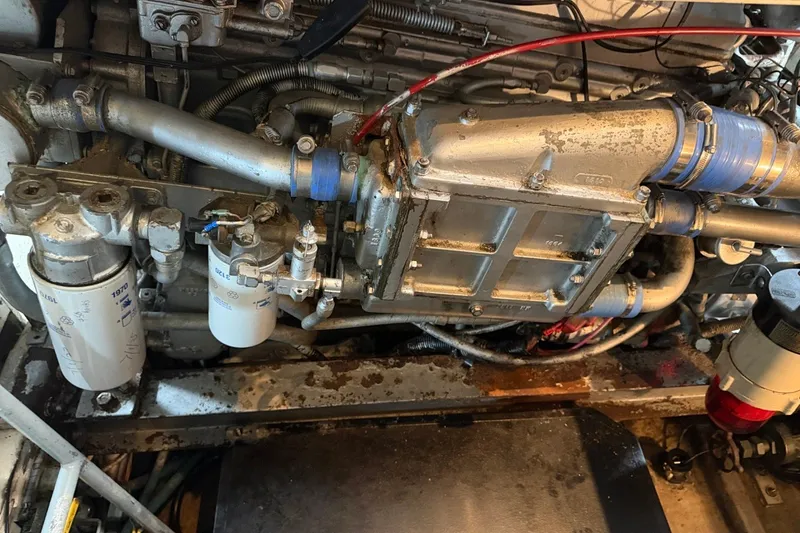 Slide: The Image of Engine compartment of a 1990 Viking 44 Motor Yacht, showcasing mechanical components and filters. - 45