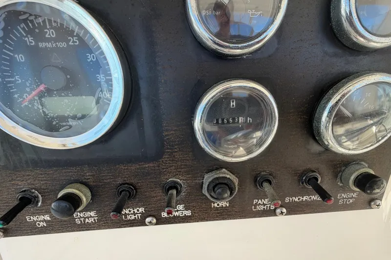 Slide: The Image of Control panel of a 1990 Viking 44 Motor Yacht with gauges and switches. - 29