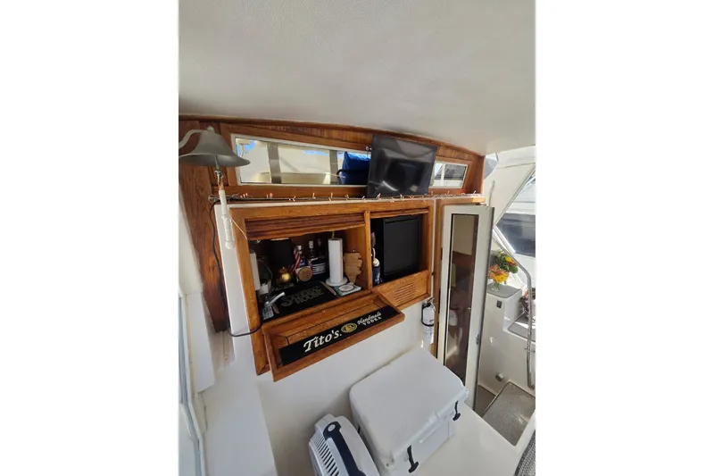 Slide: The Image of Interior of 1990 Viking 44 Motor Yacht with bar area and TV setup. - 19