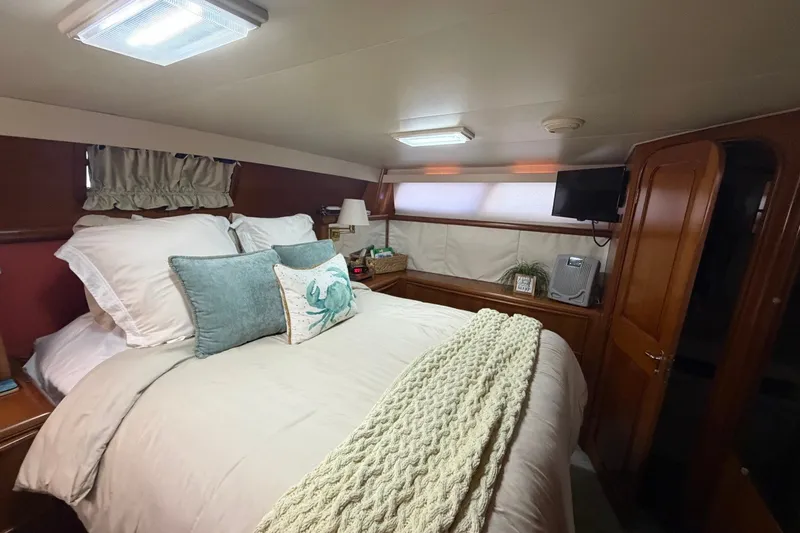 Slide: The Image of Cozy bedroom interior of 1990 Viking 44 Motor Yacht with elegant bedding and decor. - 39