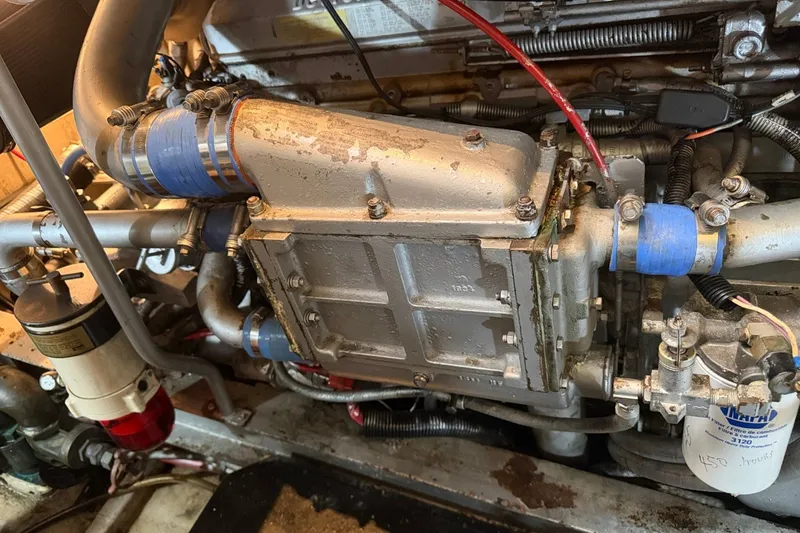 Slide: The Image of Engine compartment of a 1990 Viking 44 Motor Yacht, showcasing mechanical components and hoses. - 44