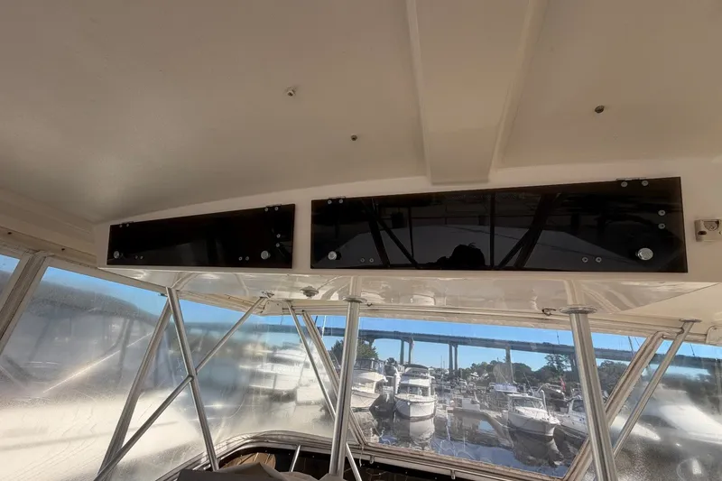 Slide: The Image of Interior view of a 1990 Viking 44 Motor Yacht with marina in background. - 25