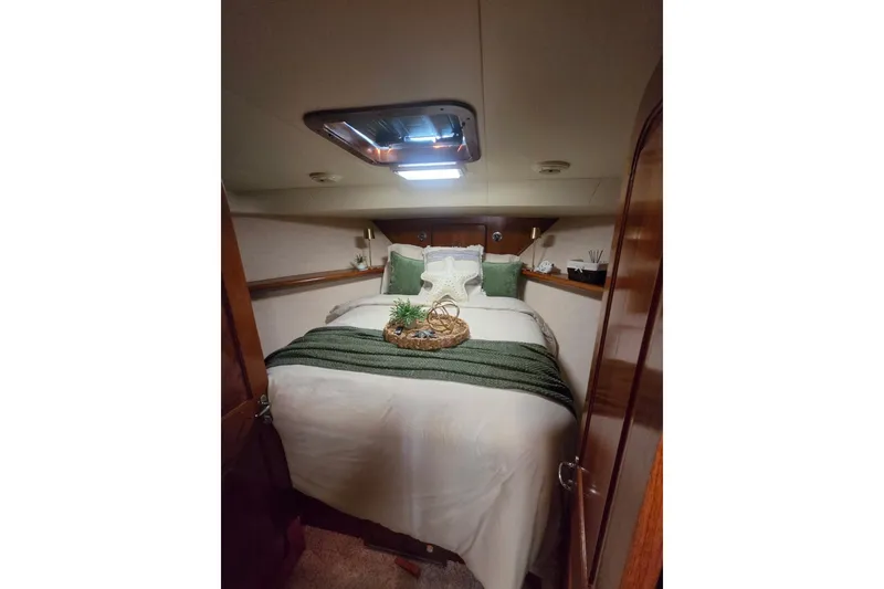 Slide: The Image of Cozy bedroom interior of 1990 Viking 44 Motor Yacht with elegant bedding and decor. - 14