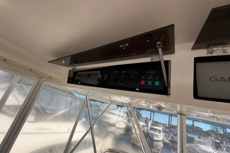 Slide: The Image of Control panel inside a 1990 Viking 44 Motor Yacht, featuring navigation equipment. - 27