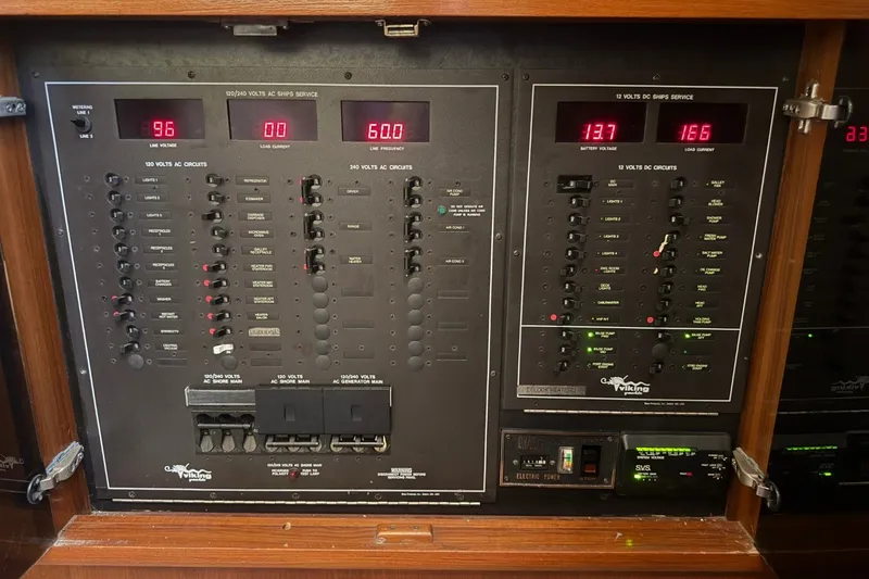 Slide: The Image of Electrical control panel of a 1990 Viking 44 Motor Yacht, displaying voltage and circuit switches. - 40