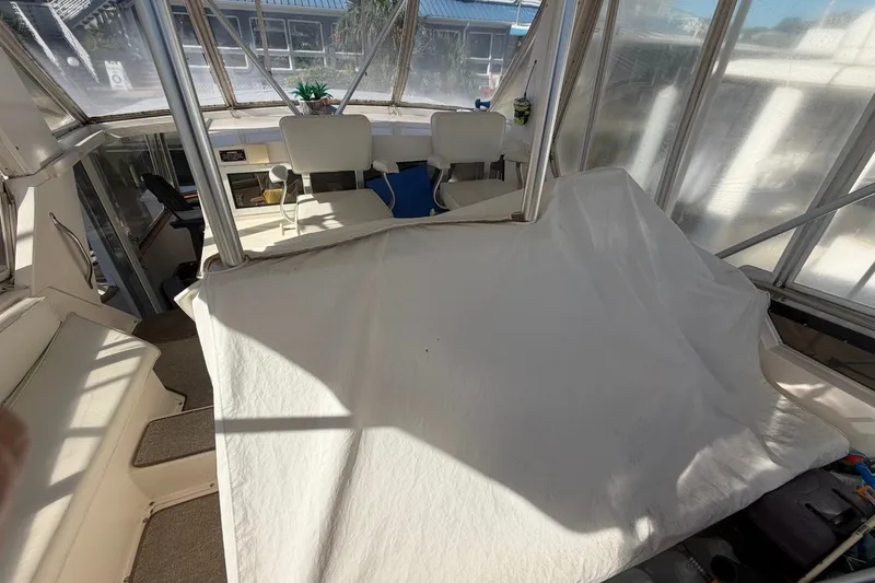Slide: The Image of Interior of a 1990 Viking 44 Motor Yacht with covered seating and helm area. - 22