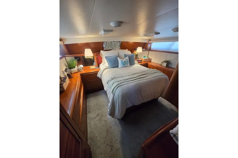 Slide: The Image of Cozy bedroom interior of 1990 Viking 44 Motor Yacht with elegant decor and soft lighting. - 13