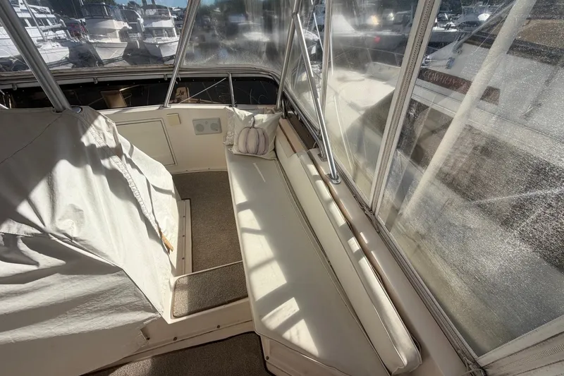 Slide: The Image of 1990 Viking 44 Motor Yacht interior with cushioned seating and clear windows. - 21