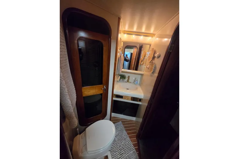 Slide: The Image of Bathroom interior of 1990 Viking 44 Motor Yacht with sink, mirror, and toilet. - 15