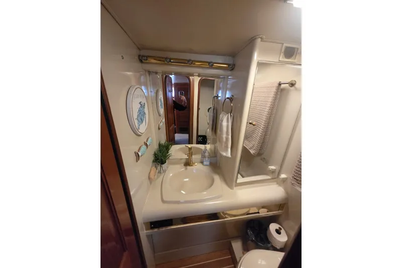 Slide: The Image of Bathroom interior of 1990 Viking 44 Motor Yacht with sink, mirror, and decor. - 16