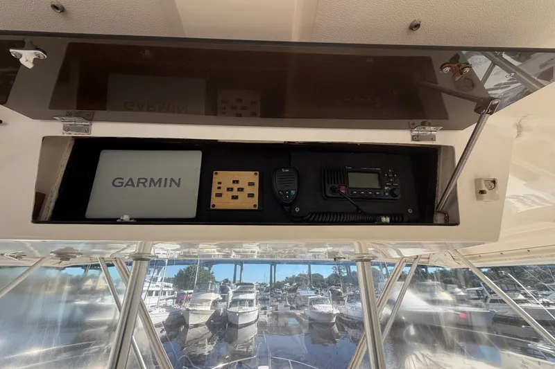Slide: The Image of 1990 Viking 44 Motor Yacht helm with Garmin navigation and communication equipment. - 26