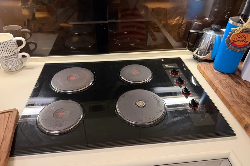 Slide: The Image of Electric stovetop in a 1990 Viking 44 Motor Yacht kitchen, with mugs and kettle nearby. - 43