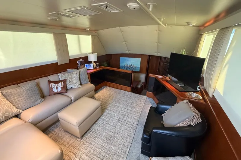 Slide: The Image of Luxurious interior of a 1990 Viking 44 Motor Yacht with cozy seating and modern decor. - 31
