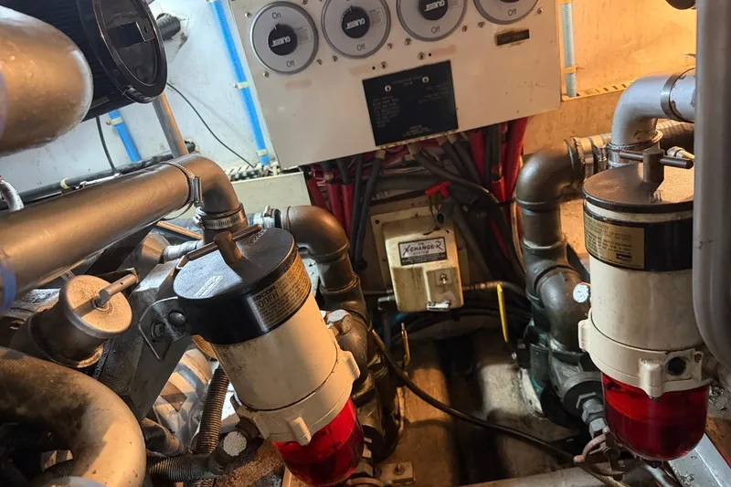 Slide: The Image of Engine room of a 1990 Viking 44 Motor Yacht with fuel filters and control panel. - 46