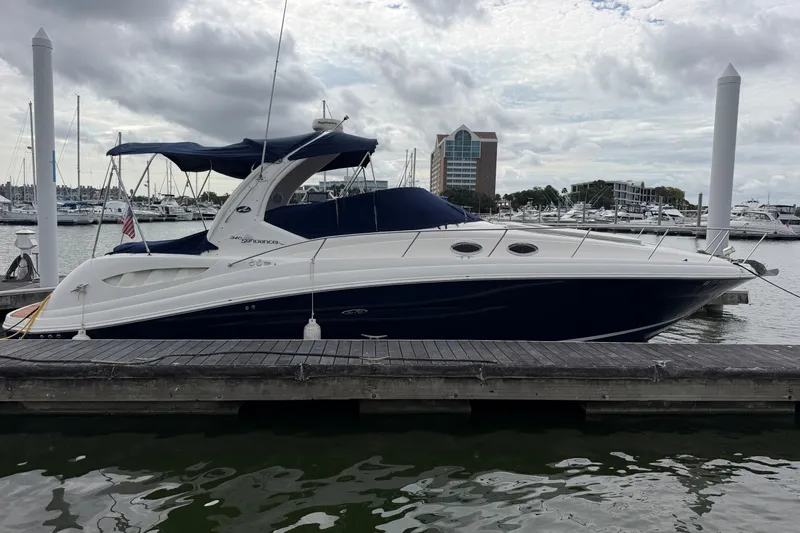 The Image of 2005 Sea Ray 340 Sundancer docked at marina under cloudy sky. - 0