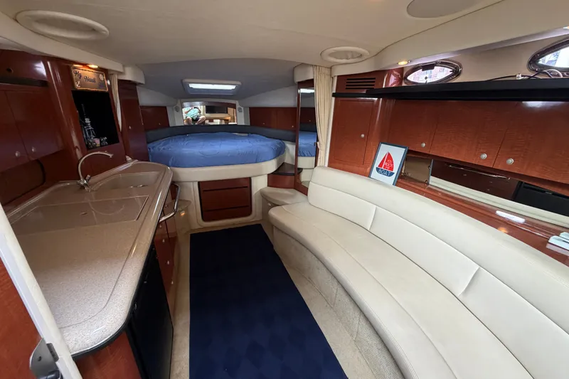 Slide: The Image of Luxurious interior of a 2005 Sea Ray 340 Sundancer yacht with cozy seating and kitchenette. - 16