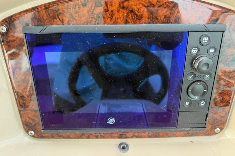 Slide: The Image of Control panel of a 2005 Sea Ray 340 Sundancer boat with wood grain finish. - 13