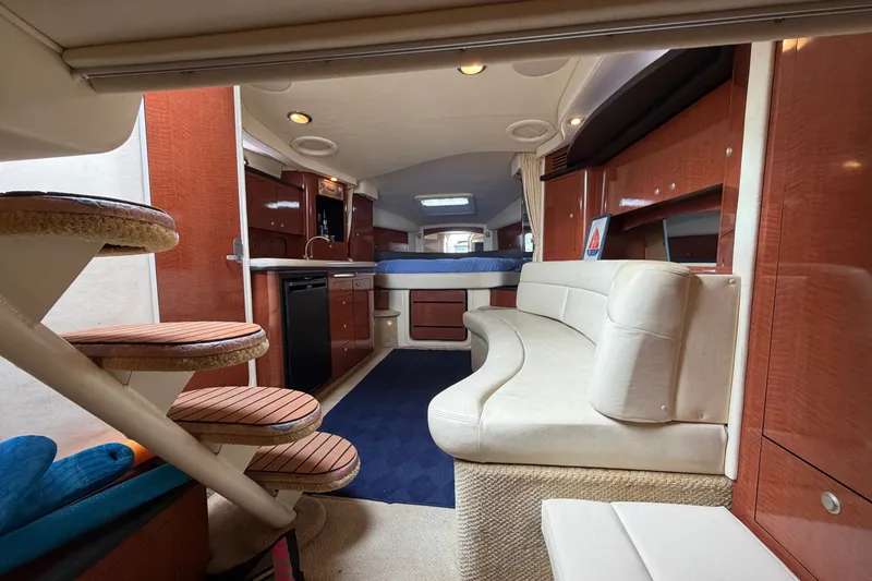 Slide: The Image of Interior of 2005 Sea Ray 340 Sundancer yacht with elegant seating and wooden cabinetry. - 22