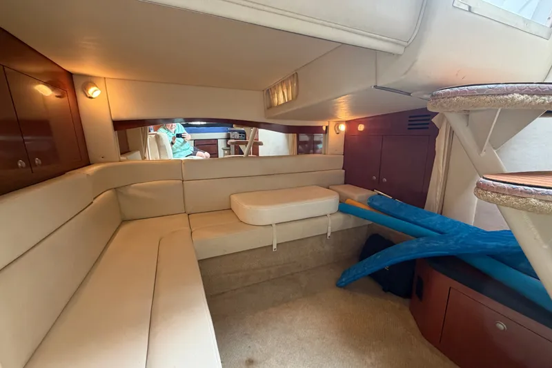 Slide: The Image of Interior of 2005 Sea Ray 340 Sundancer yacht with beige seating and wooden accents. - 21