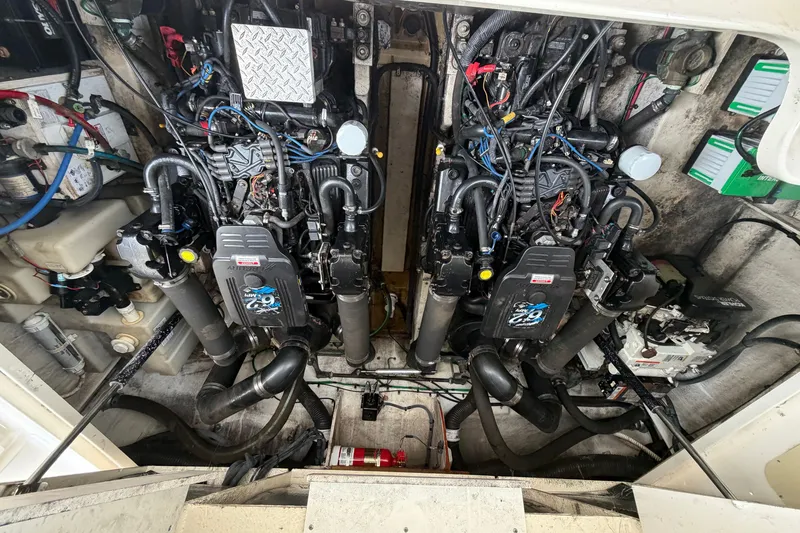 Slide: The Image of Engine compartment of a 2005 Sea Ray 340 Sundancer, showcasing dual engines and mechanical components. - 23
