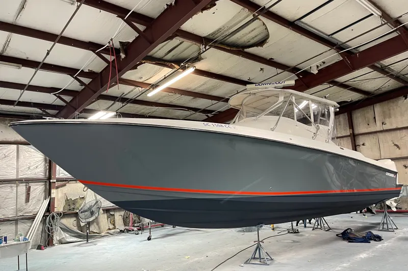 Slide: The Image of 2006 Contender 36 Fisharound boat in a warehouse, showcasing sleek design and modern features. - 1