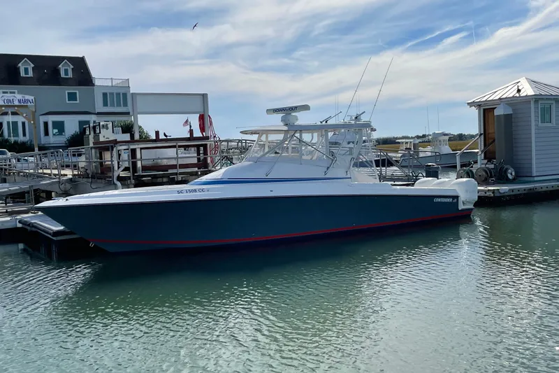 Slide: The Image of 2006 Contender 36 Fisharound boat docked at marina under clear sky. - 5