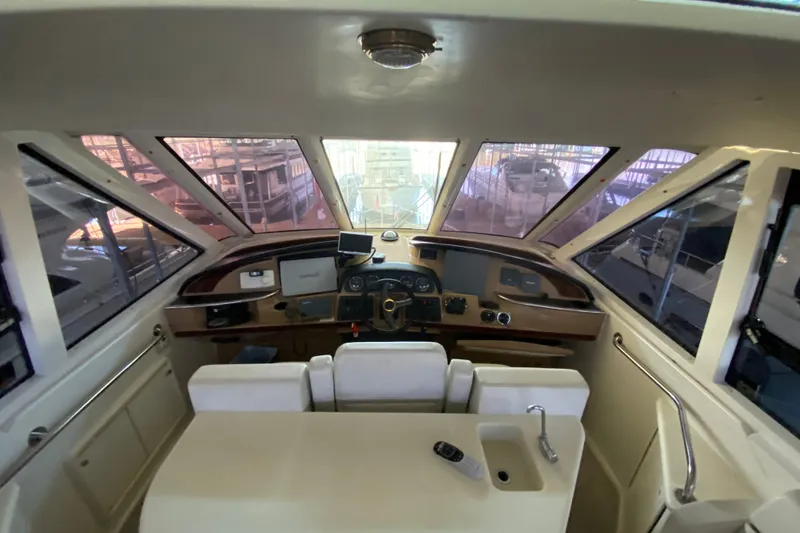 Slide: The Image of 2001 Carver 506 Motor Yacht helm with panoramic windows and modern controls. - 15