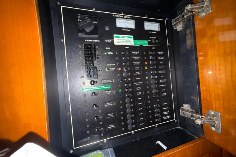 Slide: The Image of Electrical control panel inside a 2001 Carver 506 Motor Yacht, featuring switches and meters. - 36