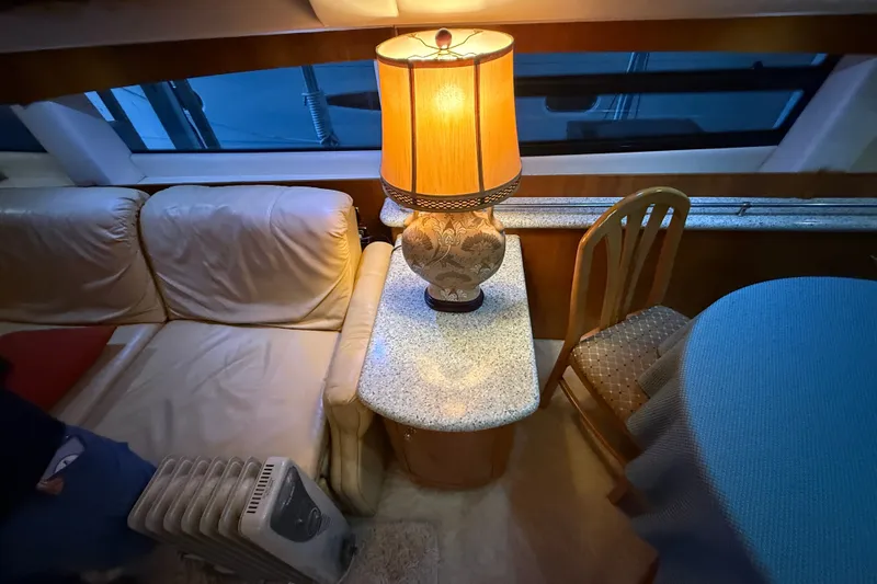 Slide: The Image of Interior of 2001 Carver 506 Motor Yacht with cozy seating and elegant lamp. - 27