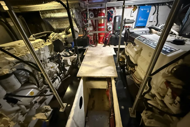 Slide: The Image of Engine room of a 2001 Carver 506 Motor Yacht, showcasing dual engines and equipment. - 43
