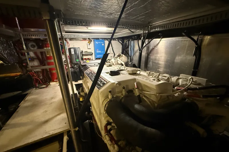 Slide: The Image of Engine room of a 2001 Carver 506 Motor Yacht, showcasing mechanical components and equipment. - 54