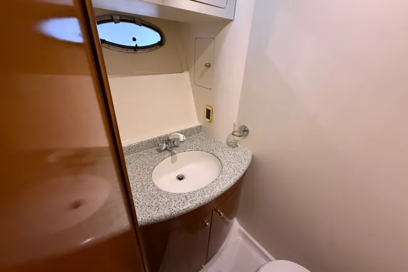 Slide: The Image of Bathroom interior of 2001 Carver 506 Motor Yacht with granite countertop and oval window. - 35