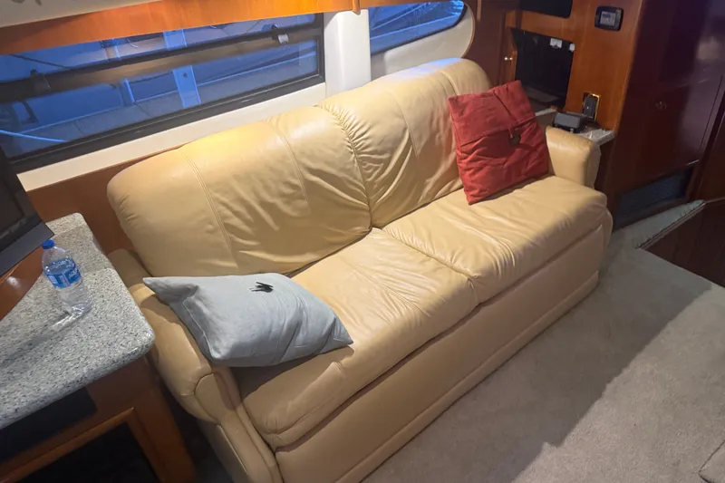 Slide: The Image of Luxurious interior of 2001 Carver 506 Motor Yacht with beige leather sofa and cushions. - 21
