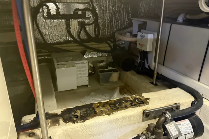 Slide: The Image of Engine room of a 2001 Carver 506 Motor Yacht with visible equipment and wiring. - 42