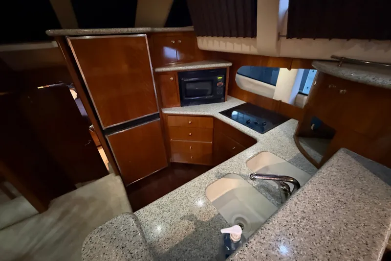 Slide: The Image of Luxurious kitchen interior of 2001 Carver 506 Motor Yacht with granite countertops and modern appliances. - 24