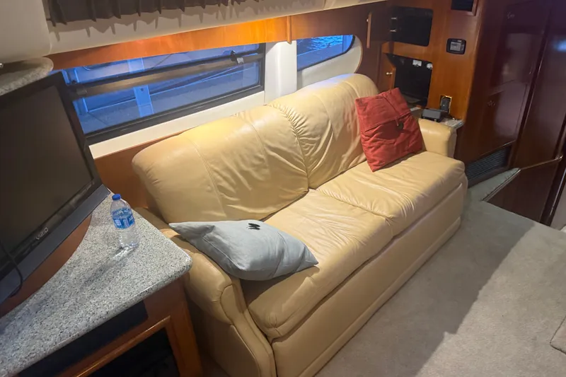 Slide: The Image of Luxurious interior of 2001 Carver 506 Motor Yacht with beige leather sofa and TV. - 22