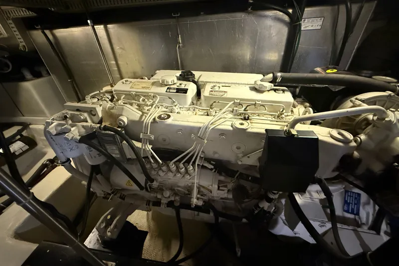 Slide: The Image of Engine room of a 2001 Carver 506 Motor Yacht, showcasing the engine components. - 44