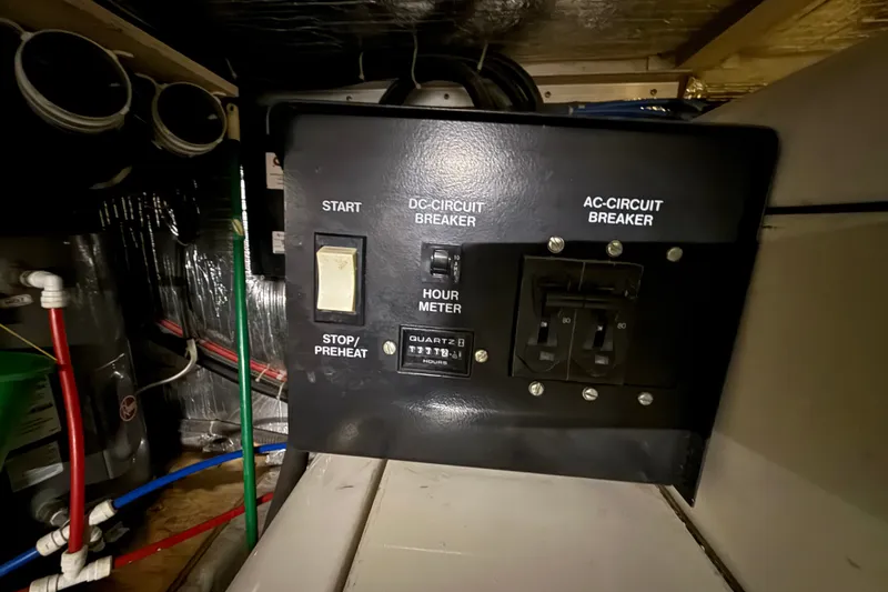Slide: The Image of Control panel of a 2001 Carver 506 Motor Yacht with circuit breakers and hour meter. - 47