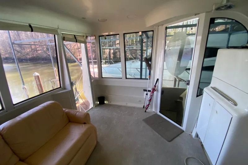 Slide: The Image of Interior of 2001 Carver 506 Motor Yacht with beige seating and large windows. - 13