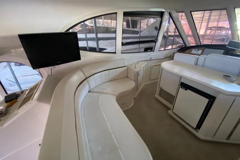 Slide: The Image of Interior of 2001 Carver 506 Motor Yacht with seating, TV, and kitchenette. - 14