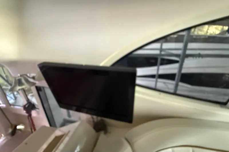 Slide: The Image of Interior of 2001 Carver 506 Motor Yacht with mounted TV and window view. - 17