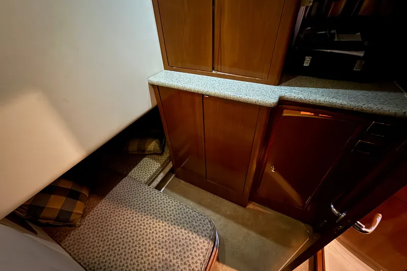 Slide: The Image of Interior cabin of 2001 Carver 506 Motor Yacht with cozy seating and wooden cabinetry. - 34