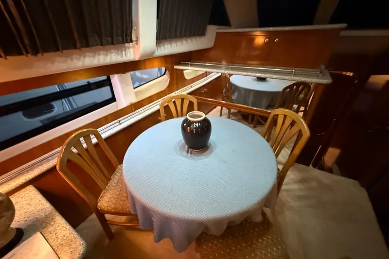 Slide: The Image of Elegant dining area inside 2001 Carver 506 Motor Yacht with table and chairs. - 20