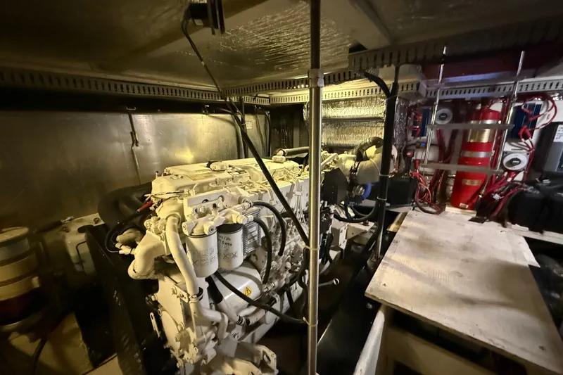 Slide: The Image of Engine room of a 2001 Carver 506 Motor Yacht, showcasing mechanical components and wiring. - 55