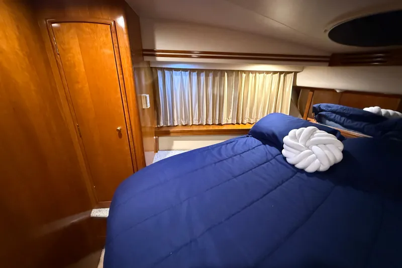 Slide: The Image of Luxurious cabin interior of 2001 Carver 506 Motor Yacht with blue bedding. - 32