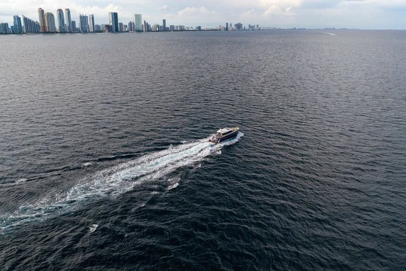 Slide: The Image of Aerial view of 2021 Steeler 60S yacht cruising near a city skyline. - 16