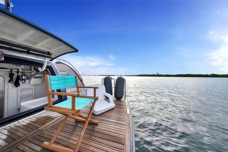 Slide: The Image of Luxury Steeler 60S yacht deck with chair, overlooking serene water and blue sky, 2021 model. - 48