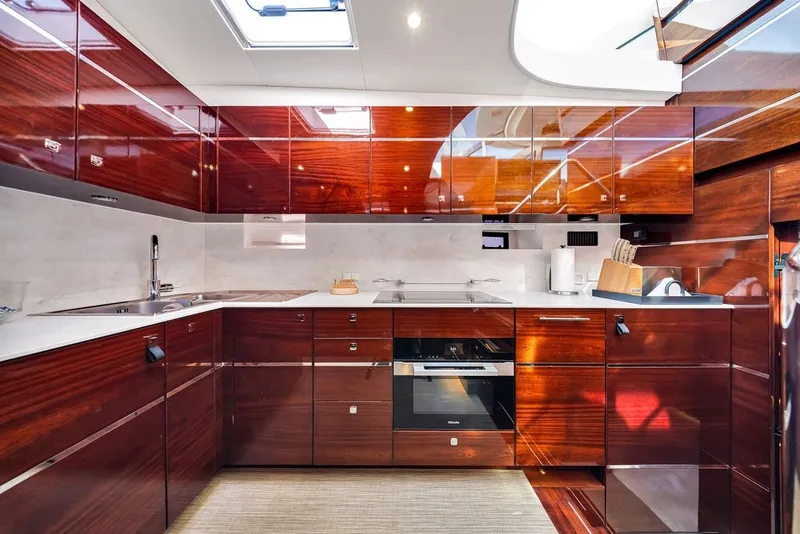Slide: The Image of Luxurious kitchen interior on a 2021 Steeler 60S yacht, featuring sleek wooden cabinetry. - 88