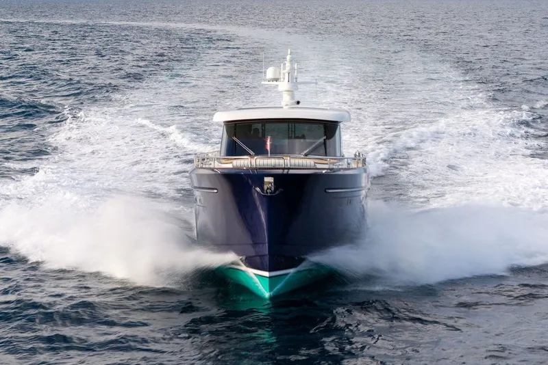 Slide: The Image of Front view of a 2021 Steeler 60S yacht cruising swiftly on open water. - 20